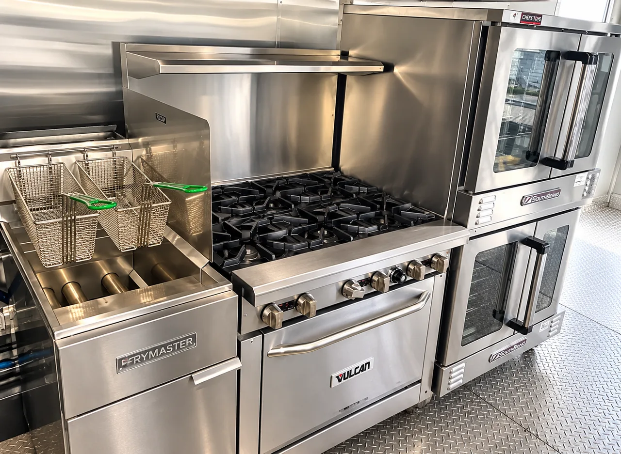 Deep fryer, gas range and ovens inside a 40 ft bulk kitchen